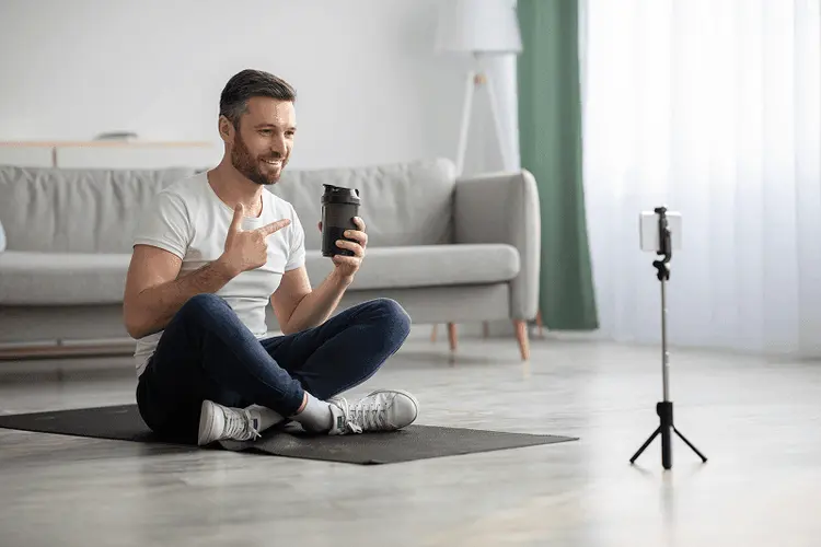 Content creator filming a product with a smartphone on a tripod