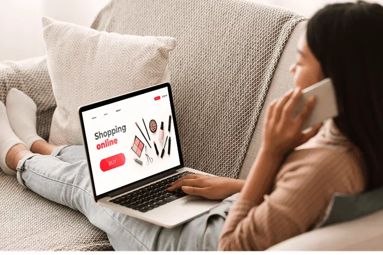 Checking a website on a laptop and phone before launching an ad campaign