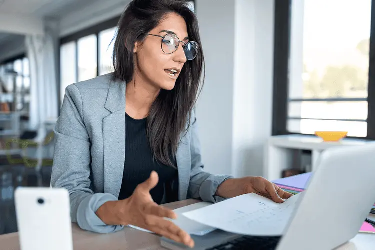 Small business owner reviewing a quote on a laptop in the office