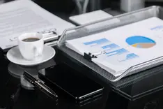 Printed report on a desk next to a pen and a cup of coffee