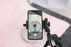 Filming a short video on a phone by a window in natural light