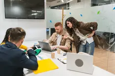 Small team working together in a workshop, candid shot