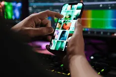 A phone in hand with a short video editing app open
