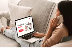Checking a website on a laptop and phone before launching an ad campaign